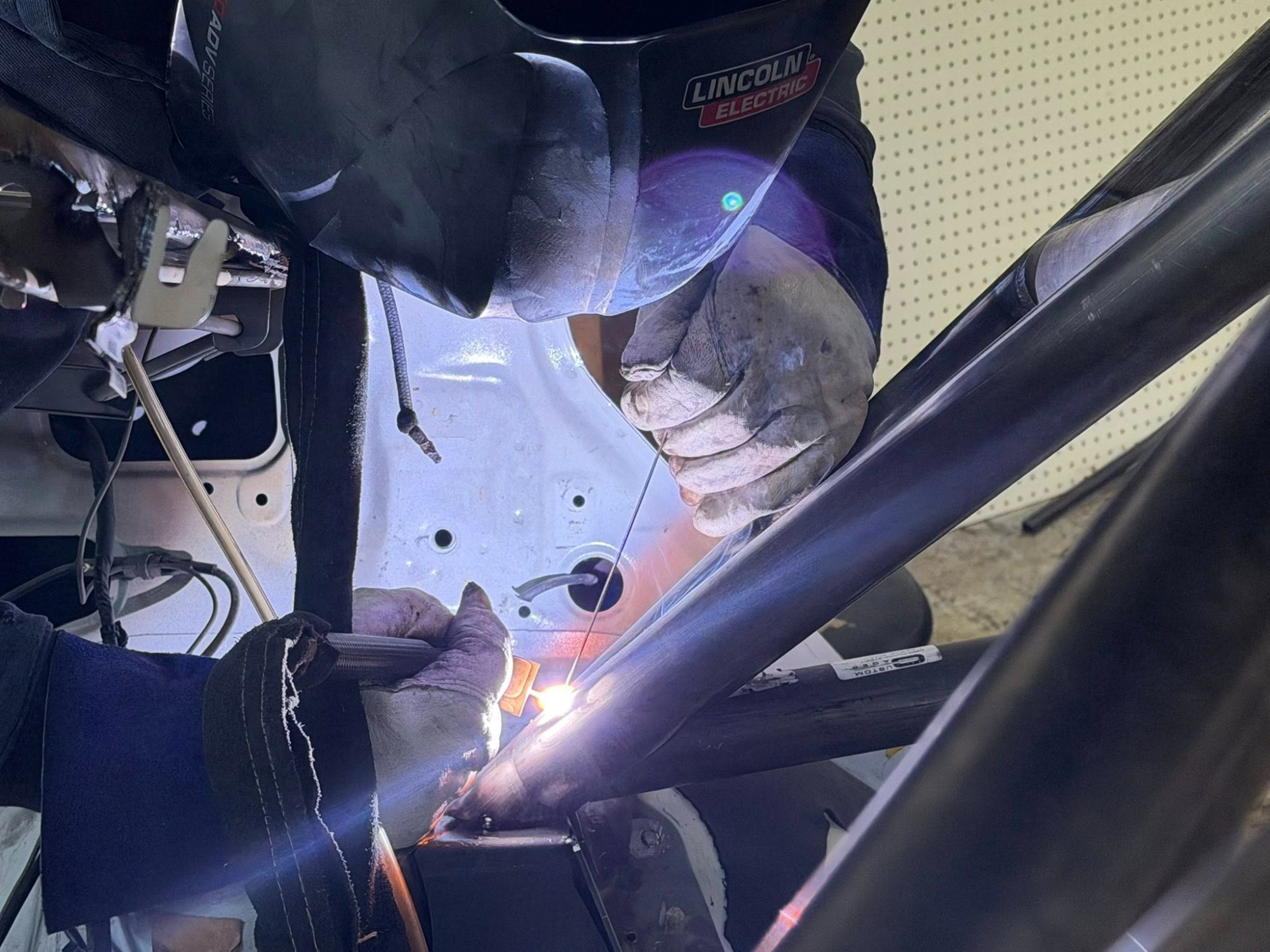 FIA roll cage being welded into the EVO III